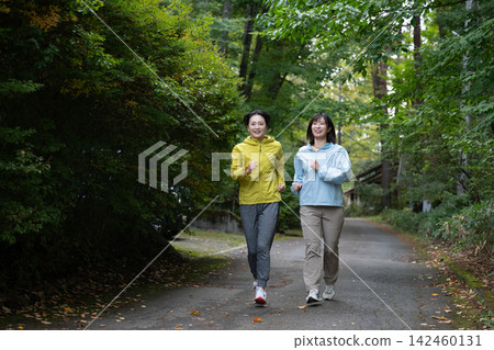 Two women jogging in the Yatsugatake Mountains. Running, jogging. Two women jogging in the Yatsugatake Mountains. Running, jogging. 142460131