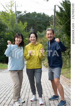 A group of three energetic people running and jogging. 142460140