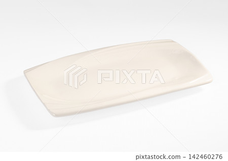 Cream ceramic serving platter with smooth curved edges on white background Cream ceramic serving platter with smooth curved edges on white background 142460276