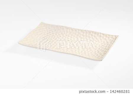 Textured off white rectangular ceramic plate with pebble pattern on clean white background Textured off white rectangular ceramic plate with pebble pattern on clean white background 142460281