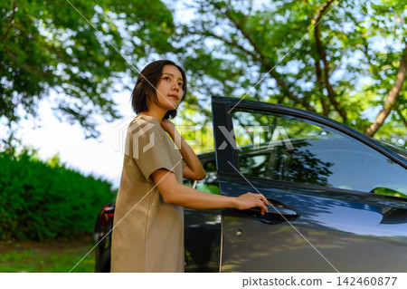 A woman getting off the car A woman getting off the car 142460877