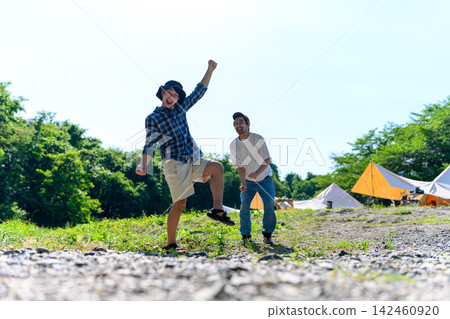 Two young people enjoying themselves at a campsite Two young people enjoying themselves at a campsite 142460920