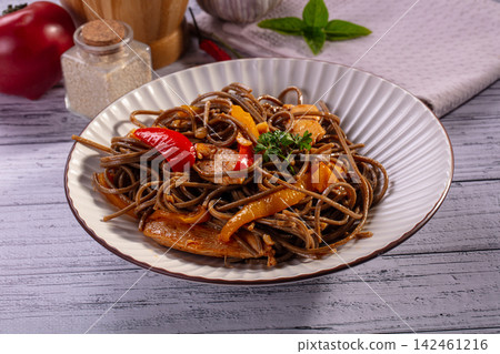 Soba noodles with chicken and bell peppers in white bowl Soba noodles with chicken and bell peppers in white bowl 142461216