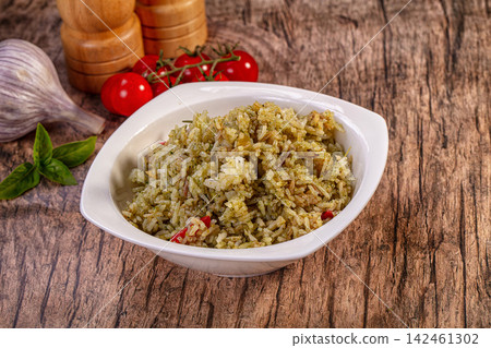 Pesto basmati rice in white bowl with fresh ingredients on wooden background 142461302