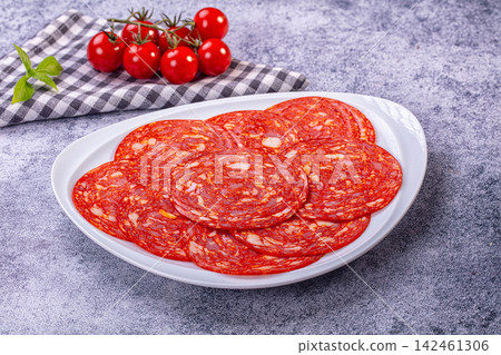 Sliced Spanish chorizo sausage on plate with fresh cherry tomatoes Sliced Spanish chorizo sausage on plate with fresh cherry tomatoes 142461306