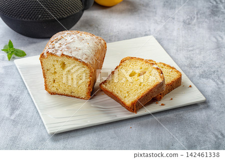 Sliced pound cake with powdered sugar on white plate Sliced pound cake with powdered sugar on white plate 142461338