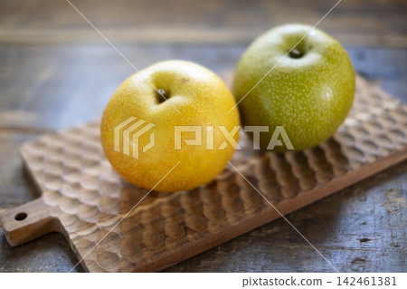 Pear on a wooden board Pear on a wooden board 142461381