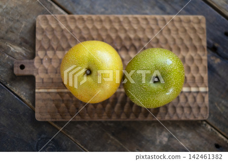 Pear on a wooden board - overhead view Pear on a wooden board - overhead view 142461382