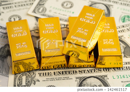 Gold bars on US dollar banknote money, finance trading investment business currency. Gold bars on US dollar banknote money, finance trading investment business currency. 142461517