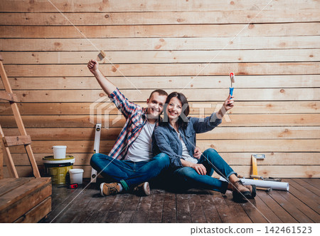 Happy couple making repairs to their home. Happy couple making repairs to their home. 142461523