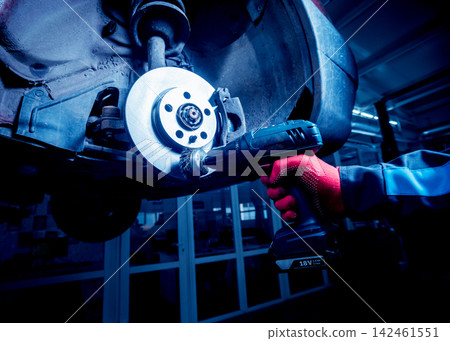 Cleaning disc brake on car, in process of new tire replacement. Cleaning disc brake on car, in process of new tire replacement. 142461551