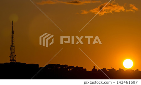 Rome at sunset timelapse with the fiery orb of the sun dropping below the horizon above the rooftops of the historical buildings Rome at sunset timelapse with the fiery orb of the sun dropping below the horizon above the rooftops of the historical buildings 142461697
