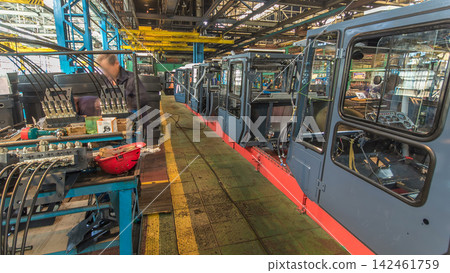 Conveyor assembly stage the body of tractor at big industrial factory timelapse Conveyor assembly stage the body of tractor at big industrial factory timelapse 142461759