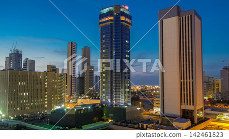 Skyline with Skyscrapers day to night timelapse in Kuwait City downtown illuminated at dusk. Kuwait City, Middle East Skyline with Skyscrapers day to night timelapse in Kuwait City downtown illuminated at dusk. Kuwait City, Middle East 142461823
