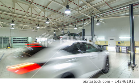 Cars moves on lifts in modern service station and men repair cars timelapse hyperlapse. Cars moves on lifts in modern service station and men repair cars timelapse hyperlapse. 142461915