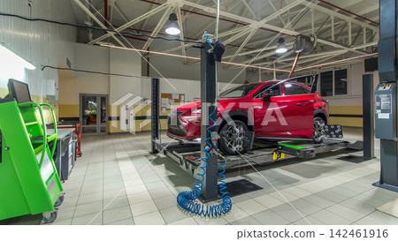 Car on stand with sensors on wheels for wheels alignment camber check in workshop of Service station timelapse. Car on stand with sensors on wheels for wheels alignment camber check in workshop of Service station timelapse. 142461916