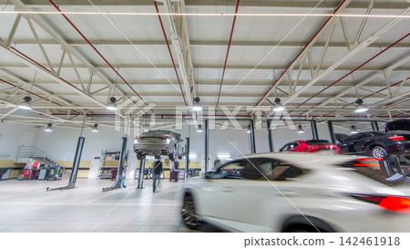Cars moves on lifts in modern service station and men repair cars timelapse. Cars moves on lifts in modern service station and men repair cars timelapse. 142461918