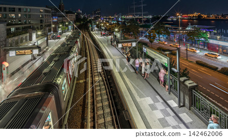 Aerial day to night timelapse of trains arriving at Landungsbrucken station in Hamburg, Germany. Aerial day to night timelapse of trains arriving at Landungsbrucken station in Hamburg, Germany. 142462006