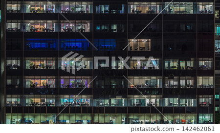 Modern office building with big windows at night timelapse, in windows light shines Modern office building with big windows at night timelapse, in windows light shines 142462061