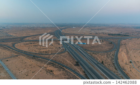 Highway roads with traffic night to day timelapse in a big city from Ajman to Dubai before sunrise. Highway roads with traffic night to day timelapse in a big city from Ajman to Dubai before sunrise. 142462088