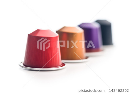 Colorful Coffee Capsules And Pods Scattered On White Background For Single-Serve Espresso Colorful Coffee Capsules And Pods Scattered On White Background For Single-Serve Espresso 142462202