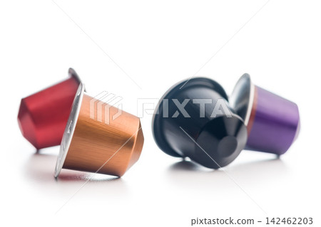 Colorful Coffee Capsules And Pods Scattered On White Background For Single-Serve Espresso Colorful Coffee Capsules And Pods Scattered On White Background For Single-Serve Espresso 142462203