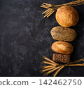 bread on dark table. different types bread on dark kitchen table, copy space for text, top view. 142462750