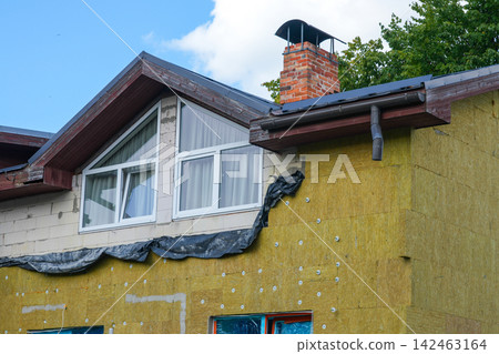 House Facade Renovation with Mineral Wool Thermal Insulation Installation and Exterior Wall Upgrade House Facade Renovation with Mineral Wool Thermal Insulation Installation and Exterior Wall Upgrade 142463164