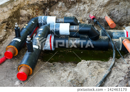 Insulated Underground District Heating Pipes Installed in Utility Trench During Infrastructure Work Insulated Underground District Heating Pipes Installed in Utility Trench During Infrastructure Work 142463170