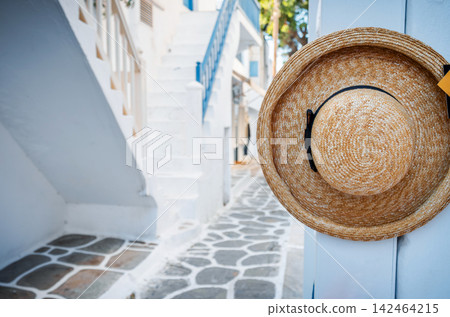 Fashionable Straw Hat Hanging On A Narrow Greek Street 142464215