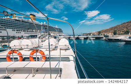 Amazing View From A Boat Of A Greek Island And Bay With A Cruise Liner In The Water Amazing View From A Boat Of A Greek Island And Bay With A Cruise Liner In The Water 142464217