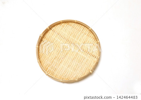 A bamboo colander against a white background. 142464483
