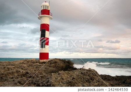 A sunrise and a red lighthouse I found in a tourist resort town in Mexico. 142464530