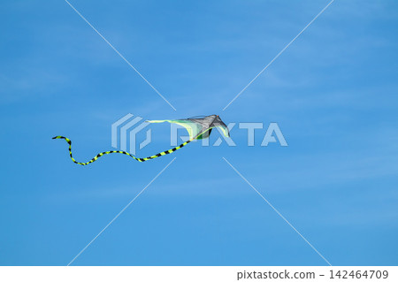 Close-up of kite flying in bright blue sky Close-up of kite flying in bright blue sky 142464709