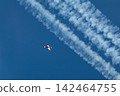 Small airplane in blue sky with white contrails 142464755