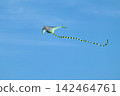 Kite toy flying close-up in bright blue sky 142464761