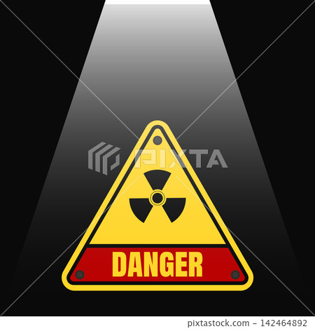 Radioactive hazard danger warning sign lit by a spotlight against a dark Radioactive hazard danger warning sign lit by a spotlight against a dark 142464892