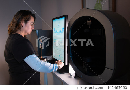 Doctor operating facial skin analysis equipment Doctor operating facial skin analysis equipment 142465060