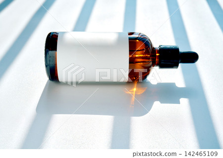 Amber serum dropper bottle with blank label Amber serum dropper bottle with blank label 142465109