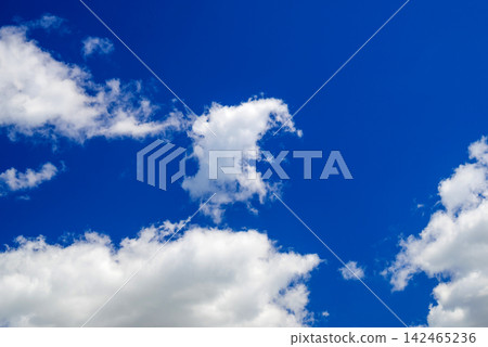 white cloud formations clustering in the lower portion of a blue sky white cloud formations clustering in the lower portion of a blue sky 142465236