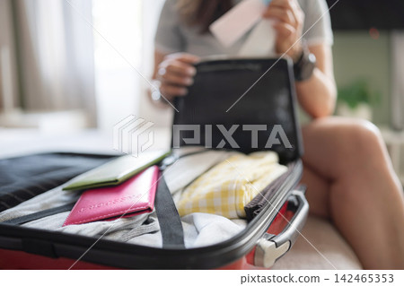Girl Packing Liquid Containers In Luggage Checking Volume To Meet 100 Ml Hand Luggage Limit 142465353