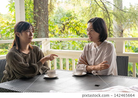 在秋日高地的一家咖啡館裡,一位女士溫柔地安慰她的朋友。 在秋日高地的一家咖啡館裡,一位女士溫柔地安慰她的朋友。 142465664
