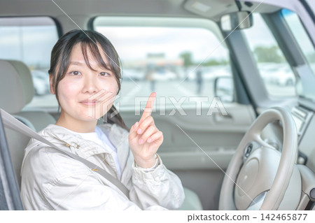 車內一名女子舉起手指 車內一名女子舉起手指 142465877