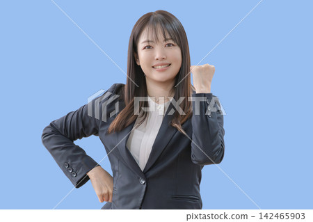 A smiling woman making a victory pose with both hands. A smiling woman making a victory pose with both hands. 142465903