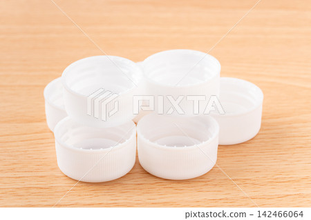 Multiple white plastic bottle caps (lids) Multiple white plastic bottle caps (lids) 142466064