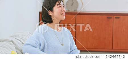 A woman listening to a conversation with interest A woman listening to a conversation with interest 142466542
