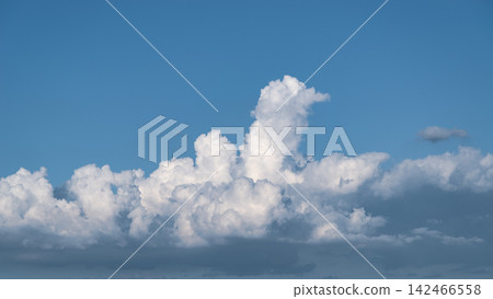 Cumulonimbus clouds developing in the distant, clear sky. (C-4 Cool Color) Cumulonimbus clouds developing in the distant, clear sky. (C-4 Cool Color) 142466558