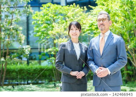 A business person looking up at the sky from a terrace. A business person looking up at the sky from a terrace. 142466943
