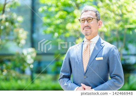 Middle-aged businessmen standing on the company terrace Middle-aged businessmen standing on the company terrace 142466948