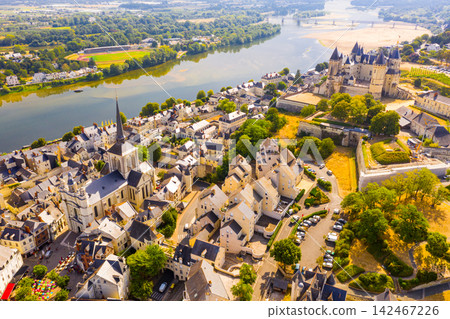 View of Saumur with medieval fortified Chateau and parish church 142467226